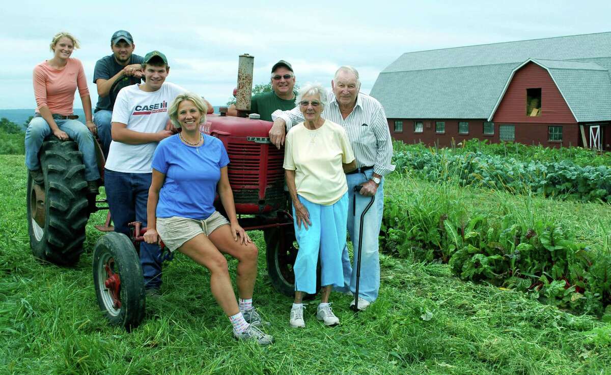 Three generations of the Weed family are farmers. Above, Wilbur “Pop” Weed and his wife, Joan, of Beacon Falls, right, join their son, Bill and Bonnie Weed, back and front, seated, of Roxbrook Farm in New Milford, and Bill and Bonnie’s sons, Ben, standing, and Dan and his wife, Felice, at Nature View Farm, the farm Dan and Felice lease in Bridgewater. September 2013. On Monday, March 14, 2016, Wilbur Weed died at age 86. For many, he was known as the “corn wall,” who sold sweet corn off Route 67 in Oxford for 45 years.