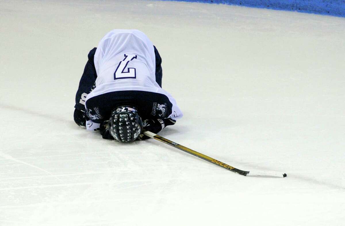 Staples-Weston-Shelton's Evan Mancini put his head down in dejection after the team was beat by Westhill-Stamford in Division III boys hockey finals action in New Haven, Conn., on Saturday March 19, 2016.