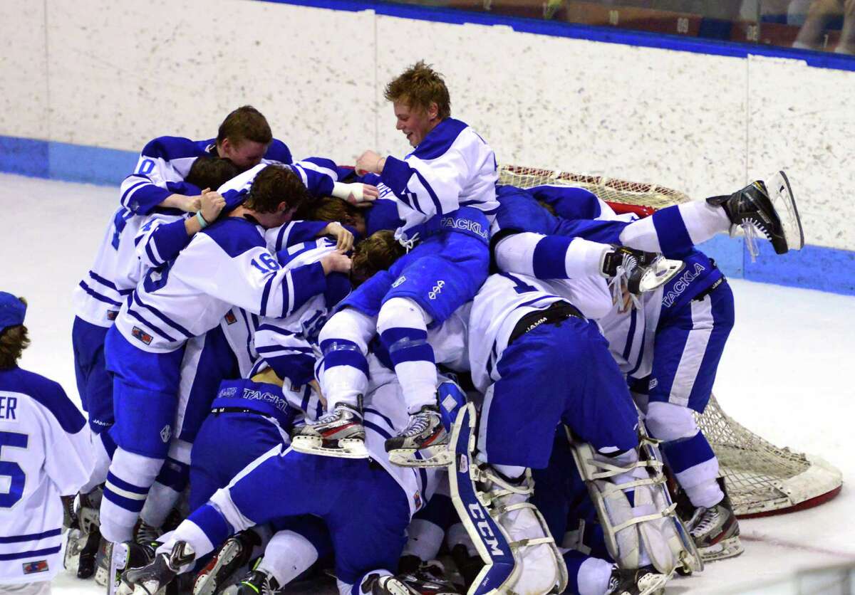 Darien celebrates its win over Fairfield Prep in Division I boys hockey finals action in New Haven, Conn., on Saturday March 19, 2016.