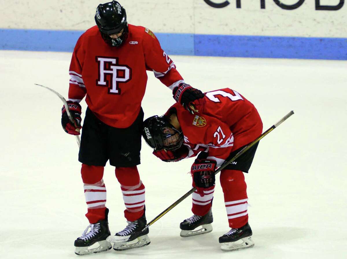 A Fairfield Prep player consoles his teammate following the Jesuits’ 4-2 loss in the Division I championship Saturday.