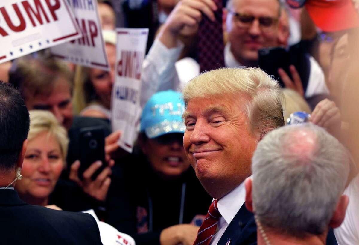 Republican presidential candidate Donald Trump smiles as he greets supporters after speaking at a campaign rally in New Orleans, Friday, March 4, 2016. (AP Photo/Gerald Herbert)