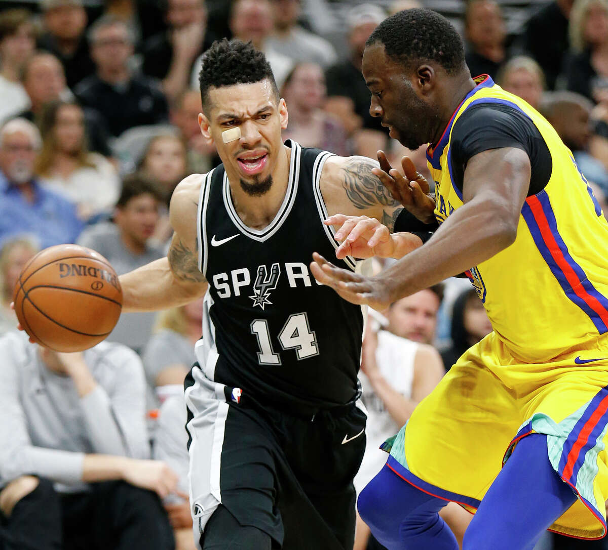 San Antonio Spurs' Danny Green looks for room around Golden State Warriors' Draymond Green during first half action Monday March 19, 2018 at the AT&T Center.