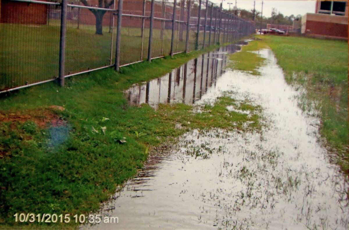 A photograph shows flooding on ﻿Harold Mathis' property in Richmond, damage from what he said came from Fort Bend County projects, including the Juvenile Probation Center on the left and the County Jail in front to the right. ﻿