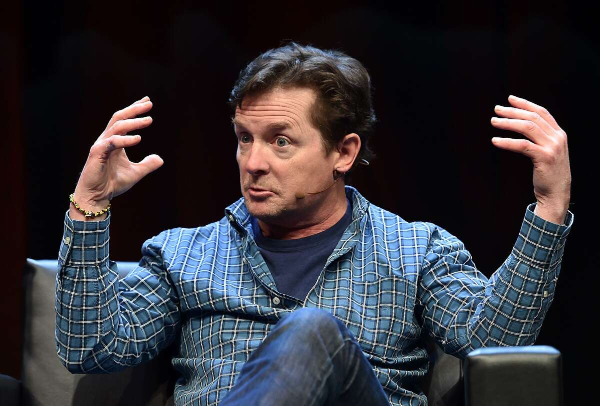 Michael J. Fox speaks to a crowd during a panel discussion about "Back to the Future" during the Silicon Valley Comic Con in San Jose, California on March 19, 2016. The comic and entertainment-themed event features exhibits, panel discussions and pop culture artistry. Fox starred in the 1985 US science-fiction adventure comedy film "Back to the Future." / AFP PHOTO / JOSH EDELSONJOSH EDELSON/AFP/Getty Images