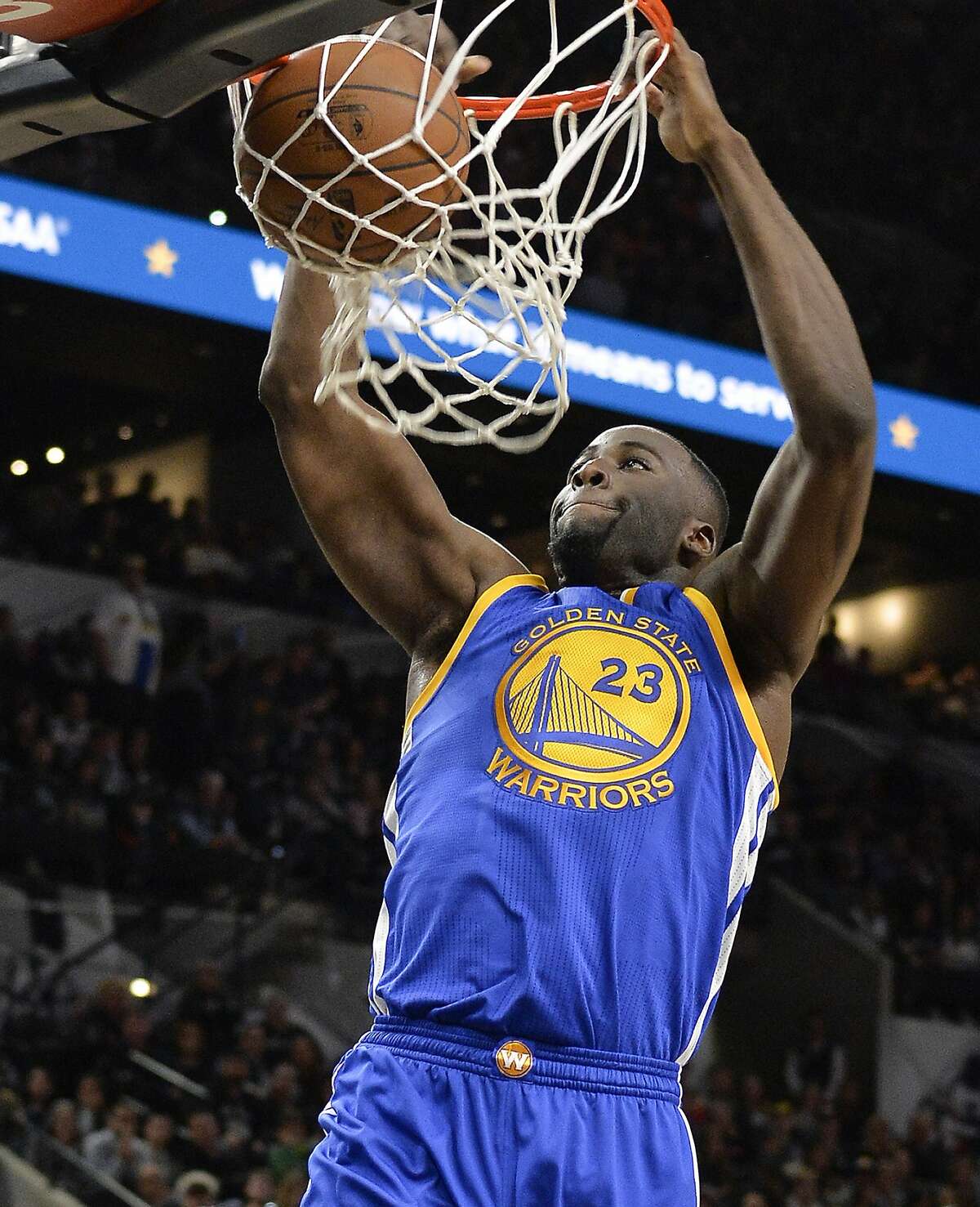 Golden State Warriors forward Draymond Green dunks during the first half of an NBA basketball game against the San Antonio Spurs, Saturday, March 19, 2016, in San Antonio. San Antonio won 87-79. (AP Photo/Darren Abate)
