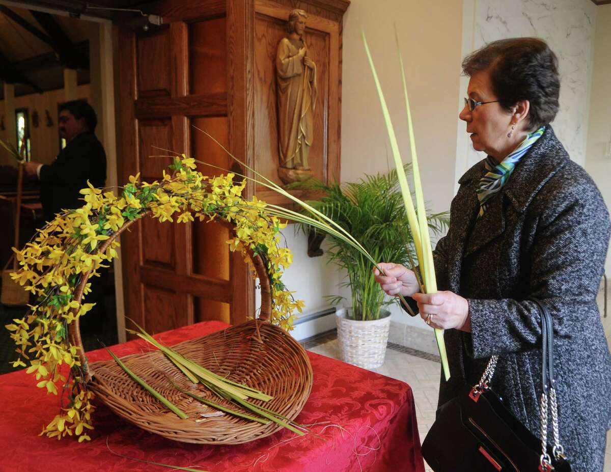Maria Castiglia gets palms before Palm Sunday mass at Sacred Heart Church in Stamford on Sunday.