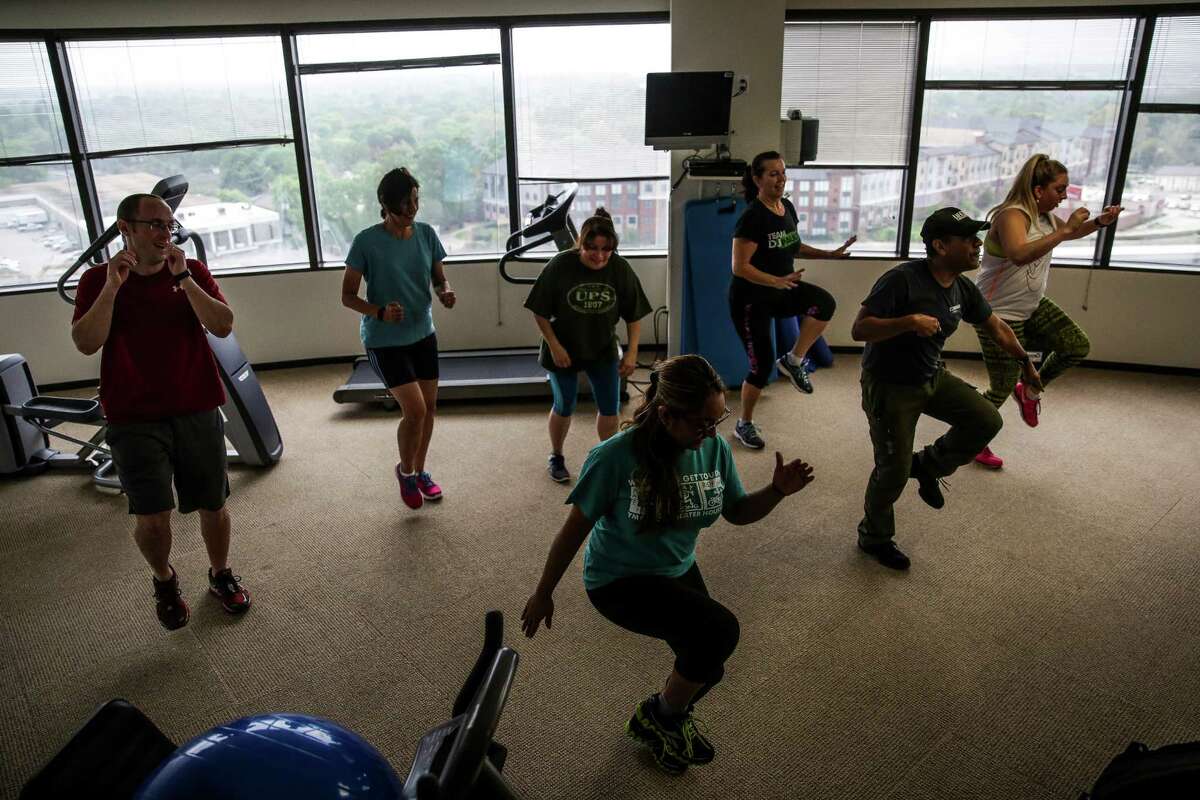 Texas Mutual Insurance Company employees dance during a latin fusion workout led by Lifetime Fitness Group Fit Instructor Roberto Cubias in the companies on-site gym Wednesday, March 16, 2016 in Houston. Cubias comes to the office once a week for a class available to the employees. ( Michael Ciaglo / Houston Chronicle )