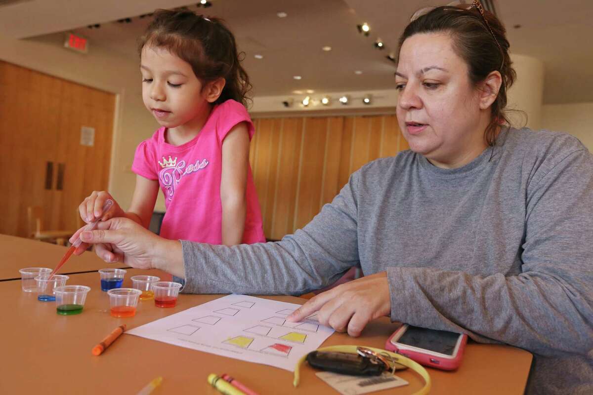 Linda Arredondo and her daughter Emily, 4, use eyedroppers to mix primary colors into secondary colors during the STEAM (Science, Technology, Engineering, Art, and Mathematics) Family Fun program held Sunday March 20, 2016 at the San Antonio Central Library.