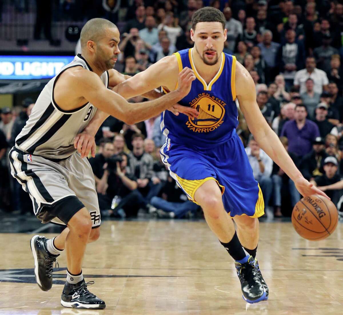 San Antonio Spurs' Tony Parker defends Golden State Warriors' Klay Thompson during second half action Saturday March 19, 2016 at the AT&T Center. The Spurs won 87-79.