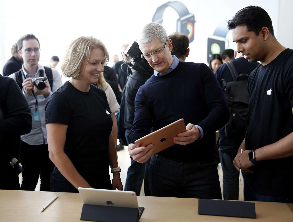 Apple CEO Tim Cook plays with a new iPad Pro during an Apple product launch event at Apple headquarters in Cupertino, California, on Monday, March 21, 2016.