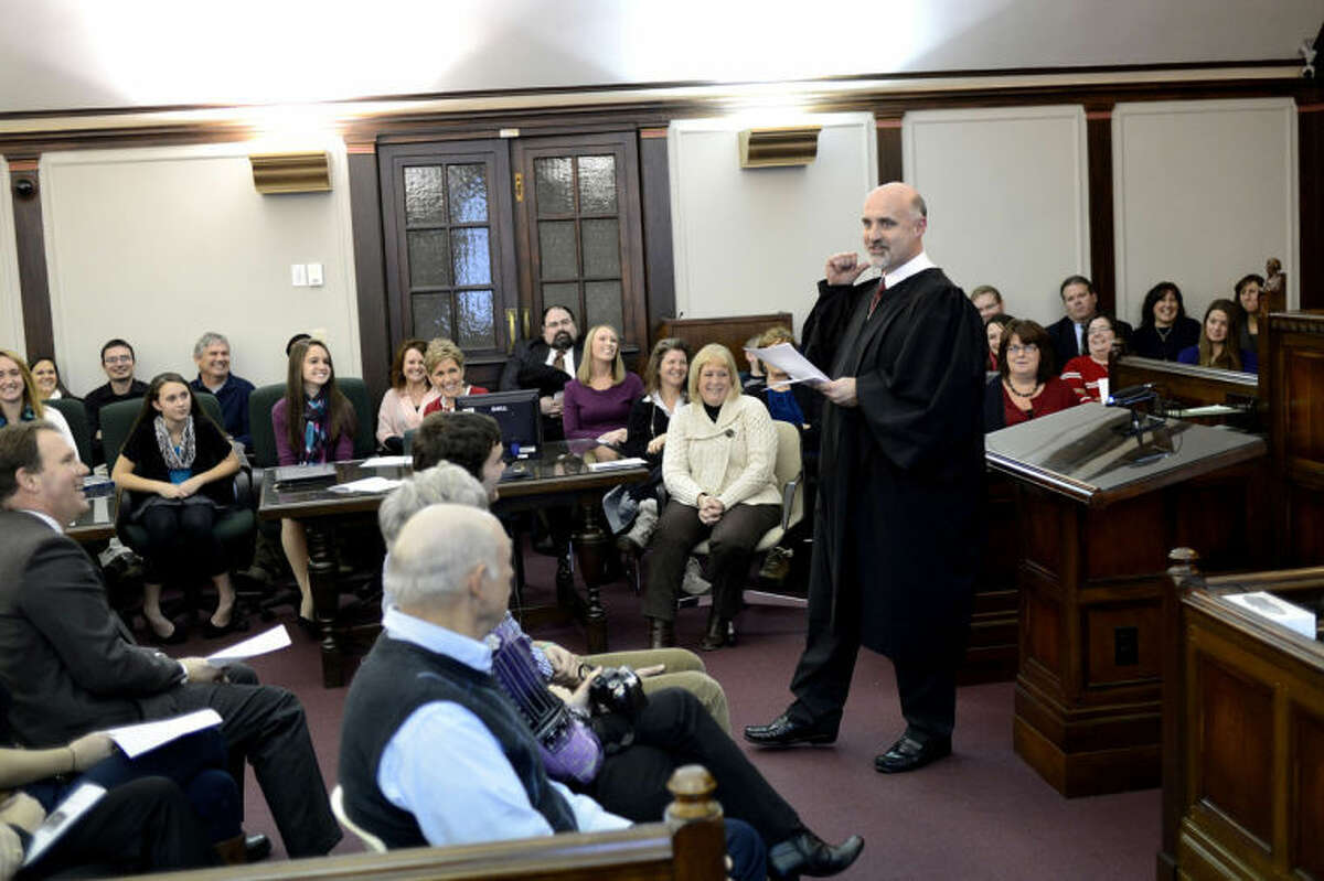 NICK KING | nking@mdn.net75th District Court Judge Michael Carpenter, right, talks to guests during his investiture ceremony Monday in the Historic Courtroom at the Midland County Courthouse.