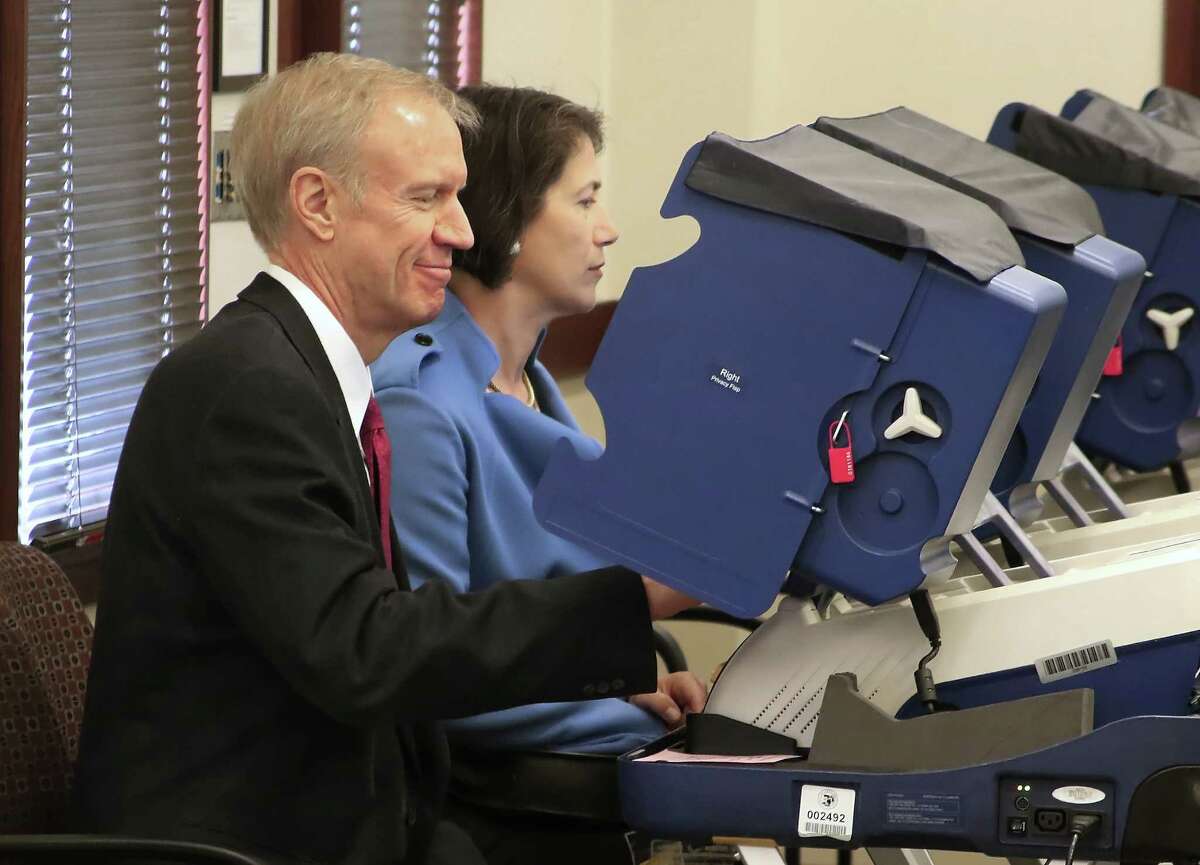 Illinois Gov. Bruce Rauner votes March 6 with his wife, Diana, in the 2016 primary election at an early voting site in Arlington Heights, Ill. Voters on the West Coast are forced to wait until the field is narrowed and front- runners are set.