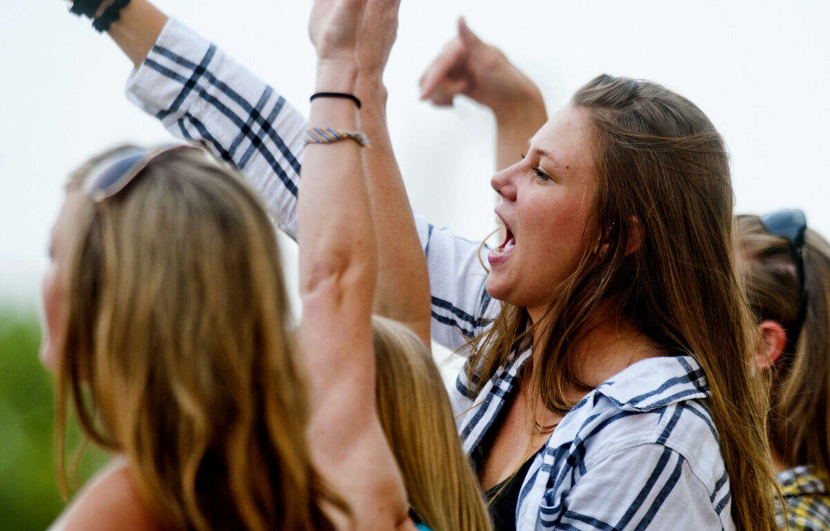 Sam Brower, 18, of Jenison, sings and dances along to a song by country singer-songwriter Sam Hunt, who opened for Little Big Town at the Midland County Fair on Sunday. "We love Sam Hunt," said Brower, adding that she and her friends came mainly to see him, and that Little Big Town was a perk.