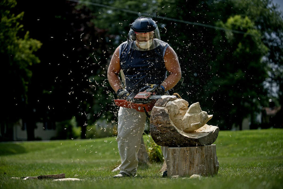 cute carved wooden mushrooms are made with a chain saw, and