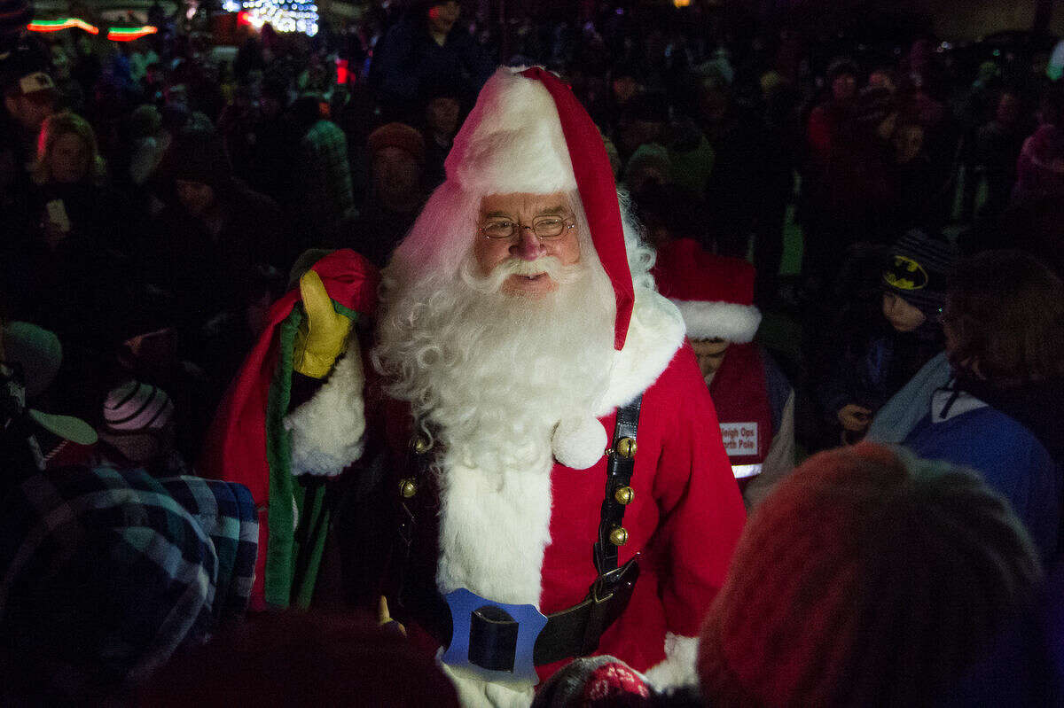 Santa Claus makes his way to the Midland County Courthouse as hundreds of people gathered in downtown Midland to see the lighting of the Tridge, the Courthouse and the Santa House on Tuesday night. Children and parents waited out in the cold for a chance to sit with Santa, and hand deliver their Christmas lists to him.