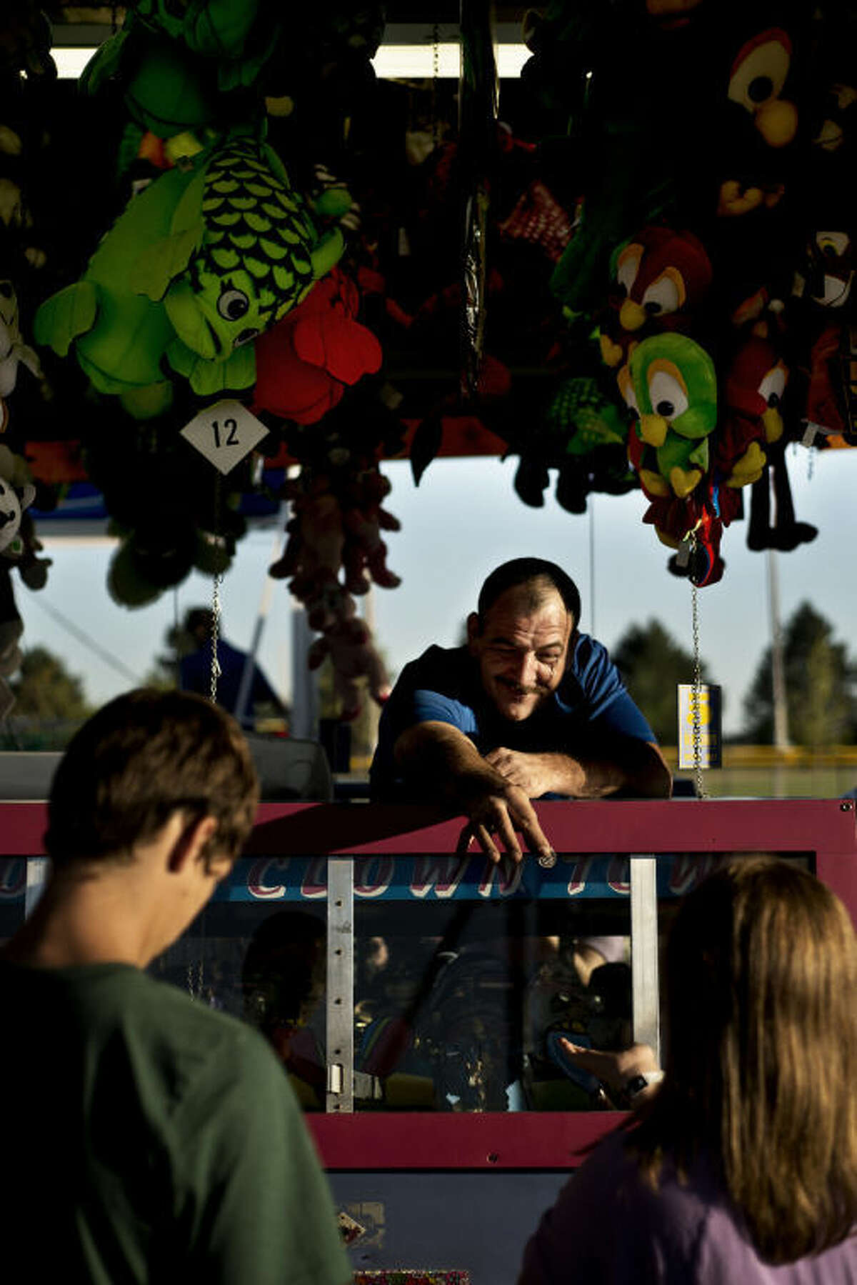 Allen Weaver, of Muskegon, mans the "Doozer" Thursday evening during the Auburn Cornfest. Weaver retired from the navy and has been working at fairs for about a year. "Everyone is happy, and that's a good thing," he said about fairs. Cornfest continues throughout the weekend with carnival games, food and live entertainment.