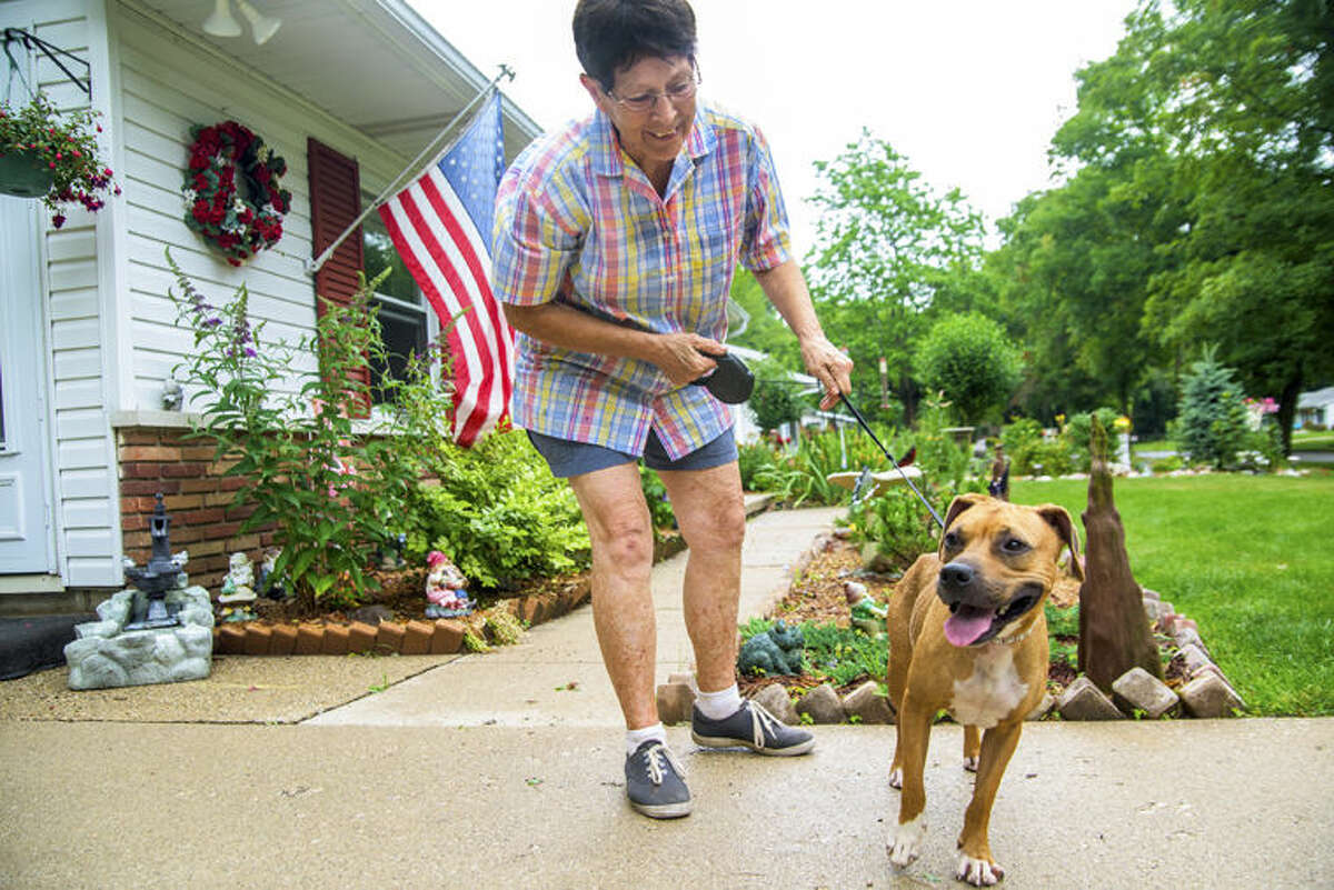 Sharon Duford plays with her newly adopted dog, Jasmine, at her Midland home. Duford adopted the mixed breed from the Humane Society of Midland County.