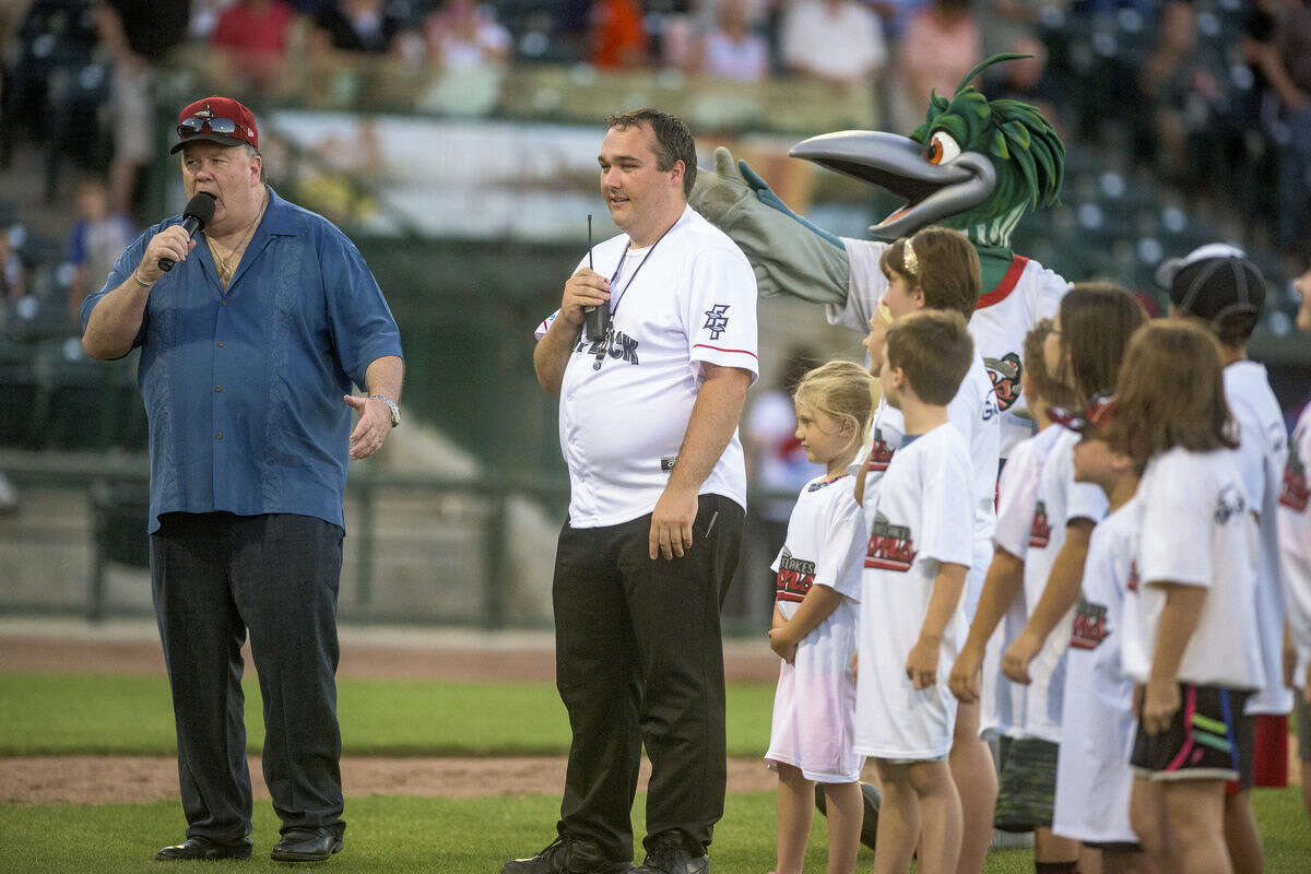 Actor Dennis Haskins, known for his role as Mr. Belding from the sitcom Saved by the Bell, sings "Take Me Out to the Ballgame" with Lou E. Loon and young fans at Dow Diamond as part of the Celebrity Guest Series in a past season.