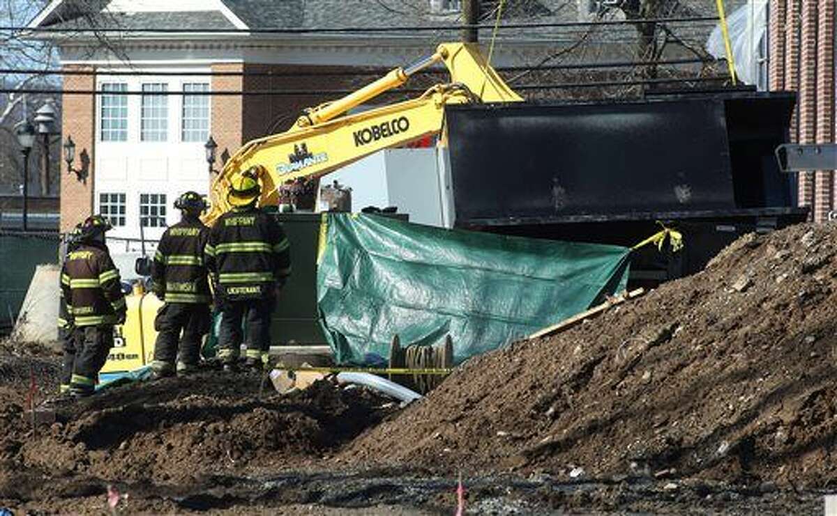 Police, firefighters and rescue workers work the scene of a construction accident involving a crane and a fallen generator at the future home of the Whippany Fire Company in Hanover, N.J., Thursday, Feb. 18, 2016. A five-ton generator fell from a crane at the construction site in northern New Jersey, killing at least one worker and severely injuring another. (Bob Karp/The Daily Record via AP) MANDATORY CREDIT