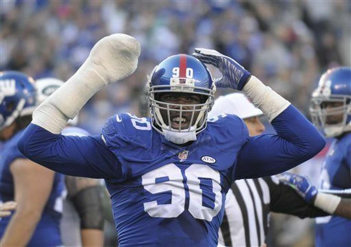 FILE - In this Dec. 6, 2015, file photo, New York Giants defensive end Jason Pierre-Paul reacts during the Giants' NFL football game against the New York Jets in East Rutherford, N.J. Pierre-Paul has filed a lawsuit seeking in more than $15,000 in damages against ESPN and reporter Adam Schefter for posting his medical records. The lawsuit, filed Wednesday, Feb. 24, 2016, in Miami Dade County in Florida, alleges that Pierre-Paul's privacy was violated-as was Florida's medical records statute-by the report last summer after the player severely injured his right hand in a fireworks accident on July 4. (AP Photo/Bill Kostroun)