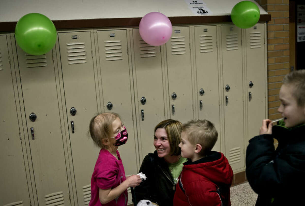 SEAN PROCTOR | sproctor@mdn.net Katie Johns, 5, left, laughs with Tara Whittington and her sons Andrew,5 and Joshua, 9 Friday night during a special charity event for Katie during the Bullock Creek boys and girls varsity basketball games against Shepherd High School. Katie, who suffers from brain cancer, and Andrew are in the same class Floyd Elementary School. Creekers for a Cause, a program at the high school, set up and ran the carnival, along with a 50/50 raffle, a halftime shootout, a silent auction and sold "Cokes for Katie." Since the original diagnosis and the subsequent doctors visits and, most recently, the chemotherapy treatments, the Johns said that community outreach has consistently poured in, including anonymous donations through the mail. "It doesn't seem like thank you is enough," Andrea, Katie's mother, said. Another benefit is currently planned for Wednesday night during the Varsity wrestling match at the High School.