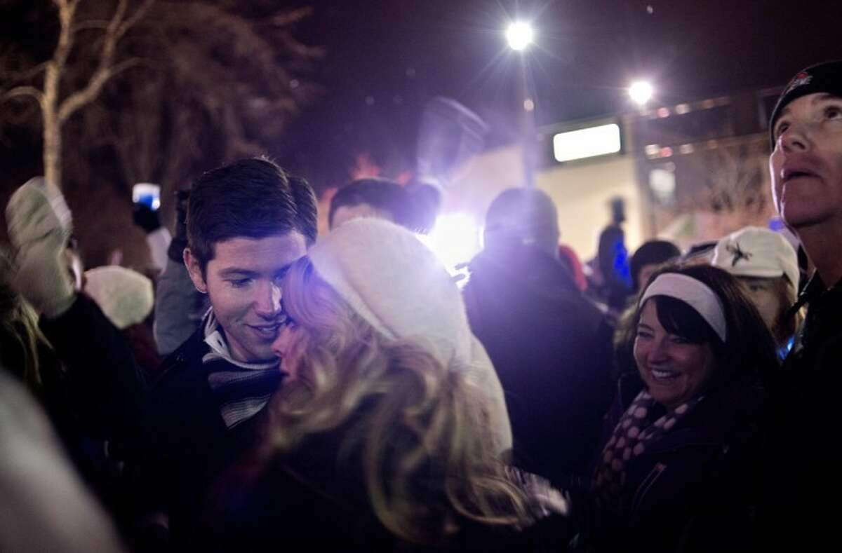 SEAN PROCTOR | sproctor@mdn.netJames Payne, of Midland, is shown with his fiancee, Mary Anderson, of Midland, after the ball drop to ring in the new year Monday night during Midnight on Main. Earlier, Payne asked Anderson on stage to ask her to marry him. "I was really ridiculously nervous all day, but once I got up there it was just me and her," Payne said. "All I saw were her eyes."