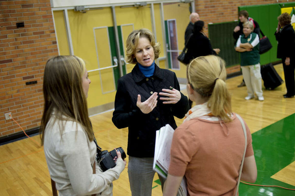 NICK KING | nking@mdn.netFormer professional tennis player and Dow graduate Meredith McGrath, center, is shown with juniors Karina Mclean, left, and Isobel Futter, right, after McGrath talked to students in the gym on Monday. Futter and Mclean were interviewing McGrath for the Dow High School newspaper.