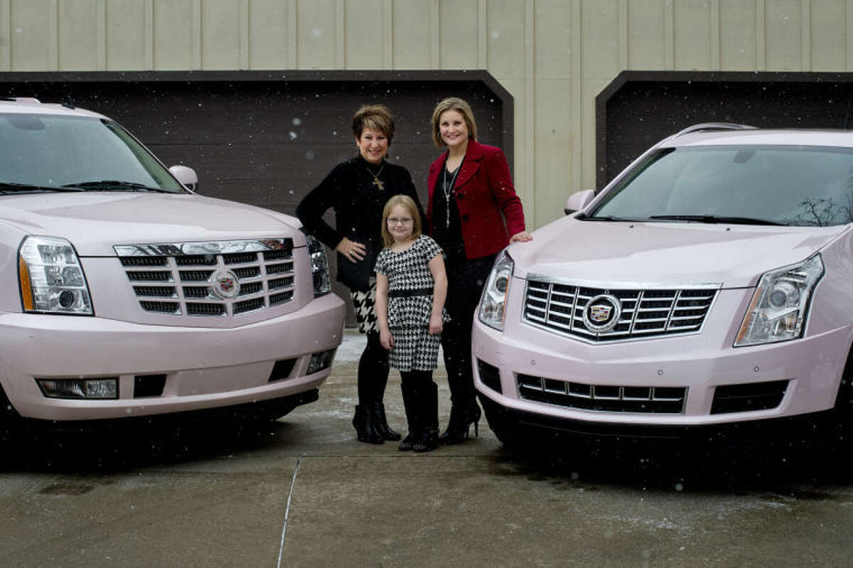 NICK KING | nking@mdn.netJudy Kawiecki, left, her grandaughter, Brynn Hansen, 6, and Brynn's mother and Judy's daughter, Lisa Hansen, pose by their pink Cadillacs which they earned the opportunity to drive based on their team production within Mary Kay.