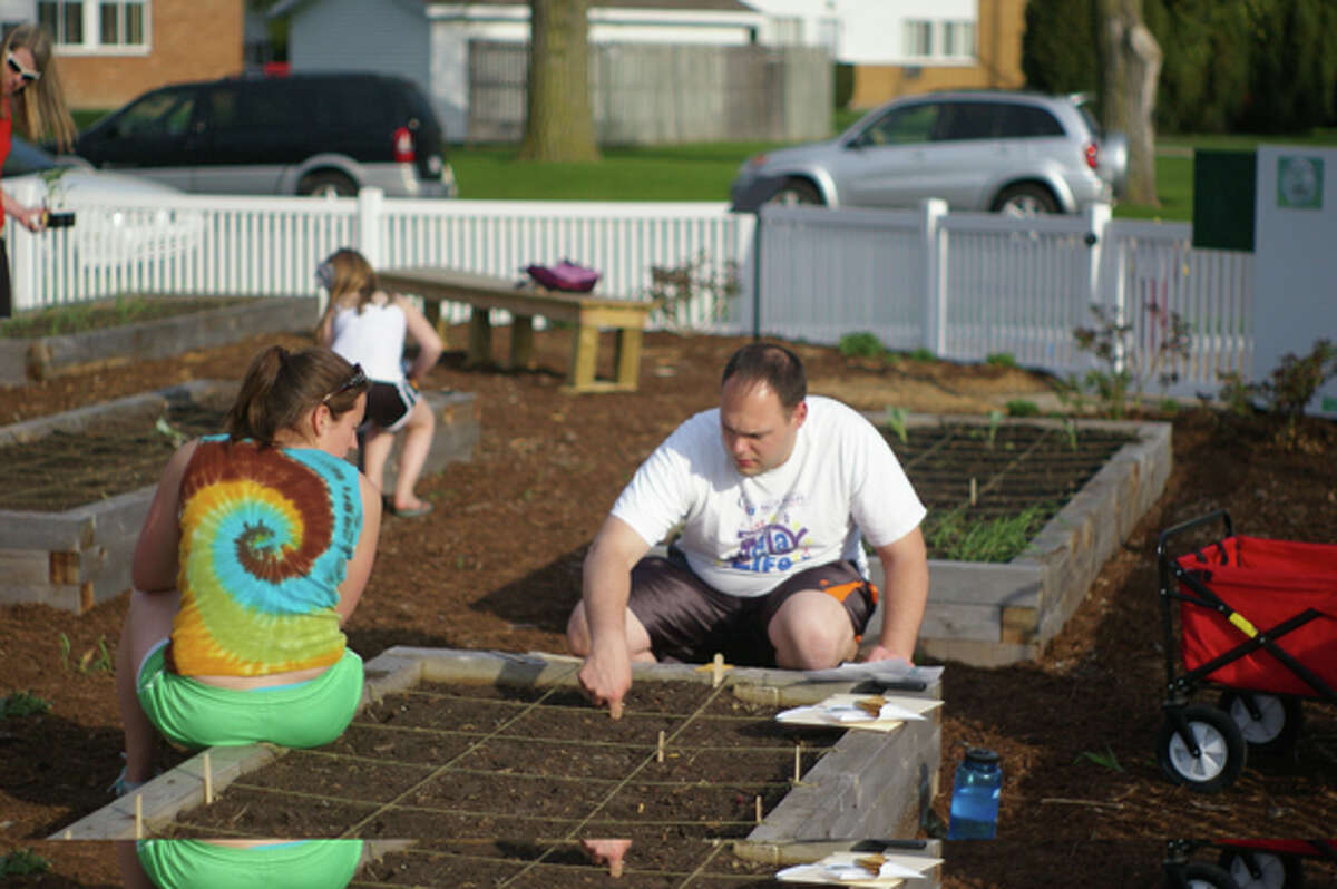 FILE — Amber and Ron Huber work in the Community Garden. Photo supplied