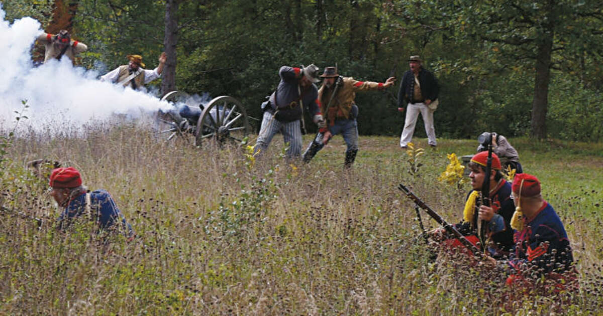 STUART FROHM| for the Daily NewsRe-enactors portraying Union and Confederate soldiers exchange fire during a mock battle Saturday at the ninth annual Mid Michigan Civil War Muster in Deerfield Nature Park west of Mount Pleasant.