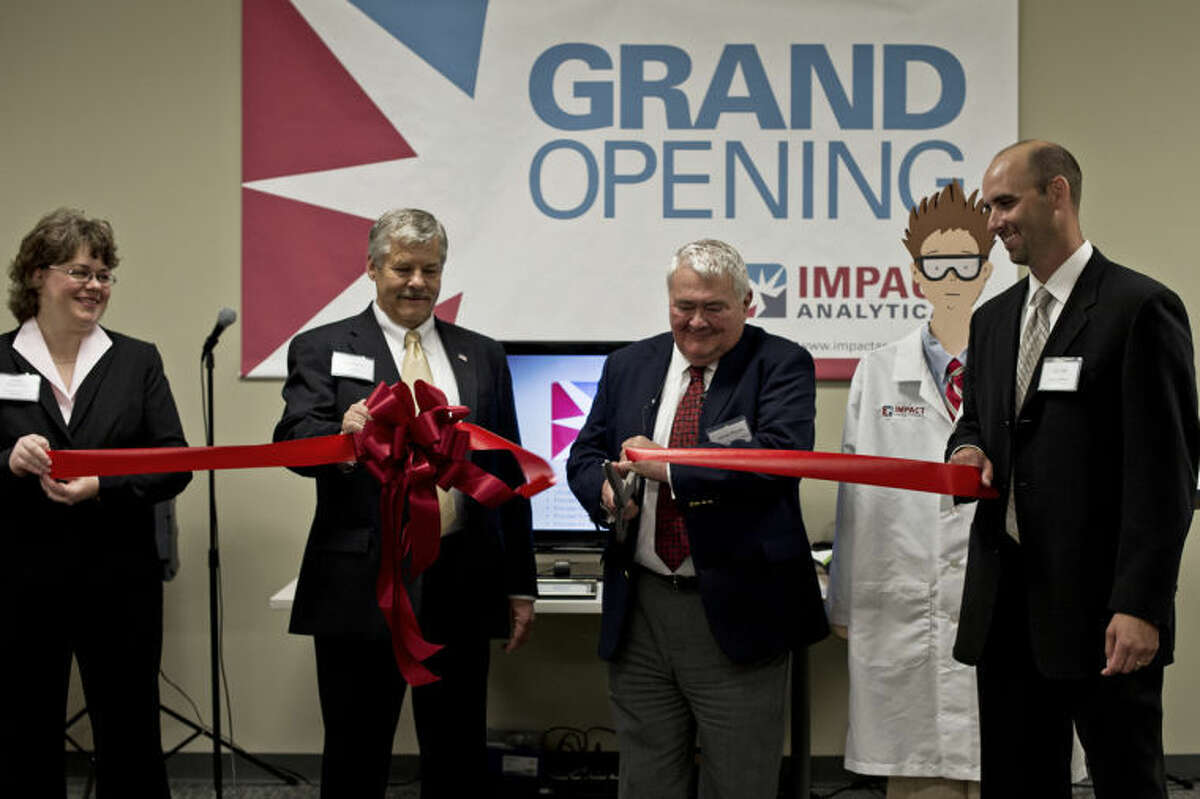 SEAN PROCTOR | sproctor@mdn.netFrom left, Kathey Robertson, Mike Murphy, James Plonka and Eric Hill help celebrate the opening of Impact Analytical's new 17,000-square-foot facility on located at 1940 Stark Road on Wednesday with a ribbon cutting. Impact Analytical provides analytical testing services to more than 300 companies worldwide, and the new state-of-the-art laboratory will aid in maximizing efficiency.
