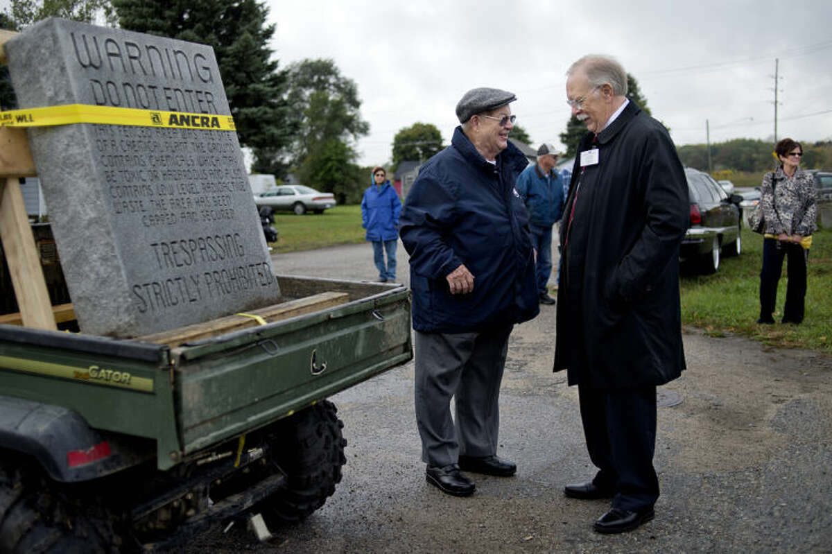 NICK KING | nking@mdn.netCity Councilman Bill Shrum, left, and Mayor Jim Kelly talk near the tombstone outside the old chemical plant site in St. Louis on Wednesday before the start of the parade to move the tombstone to its new location at the St. Louis Area Historical Society.