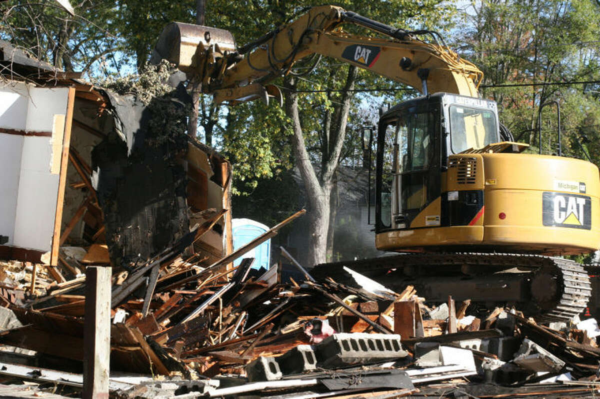 HILARY FARREL | for the Daily NewsA house is torn down this week in Saginaw, one of 950 abandoned structures to be demolished as part of the Troubled Asset Relief Program.