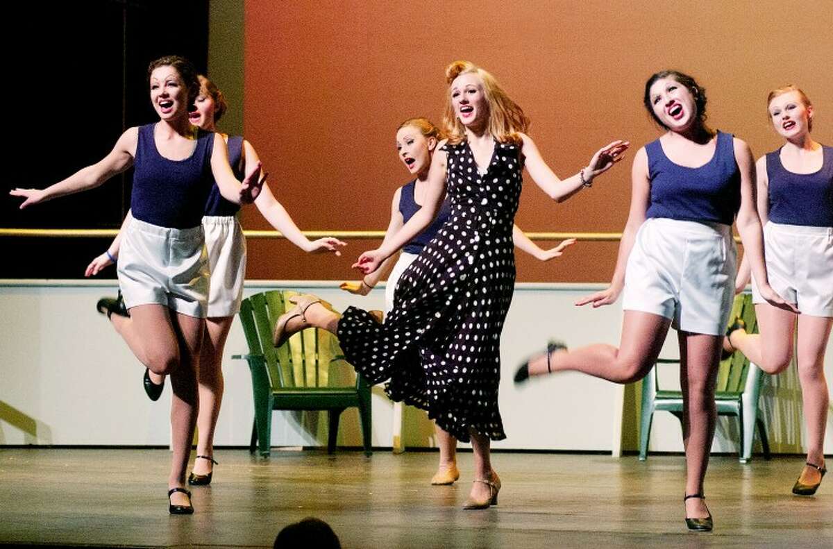 STEVEN SIMPKINS | for the Daily NewsErica Bigelow, center,  as Bonnie, dances and sings with fellow performers during a recent rehearsal of the Midland High School production of “Anything Goes.” The production opens tonight.