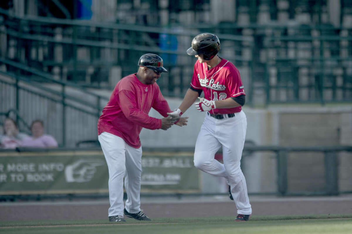 SEAN PROCTOR | sproctor@mdn.netLoons shortstop Corey Seager low fives manager Razor Shines after hitting a home run in the first inning against Lake County Monday evening at Dow Diamond.