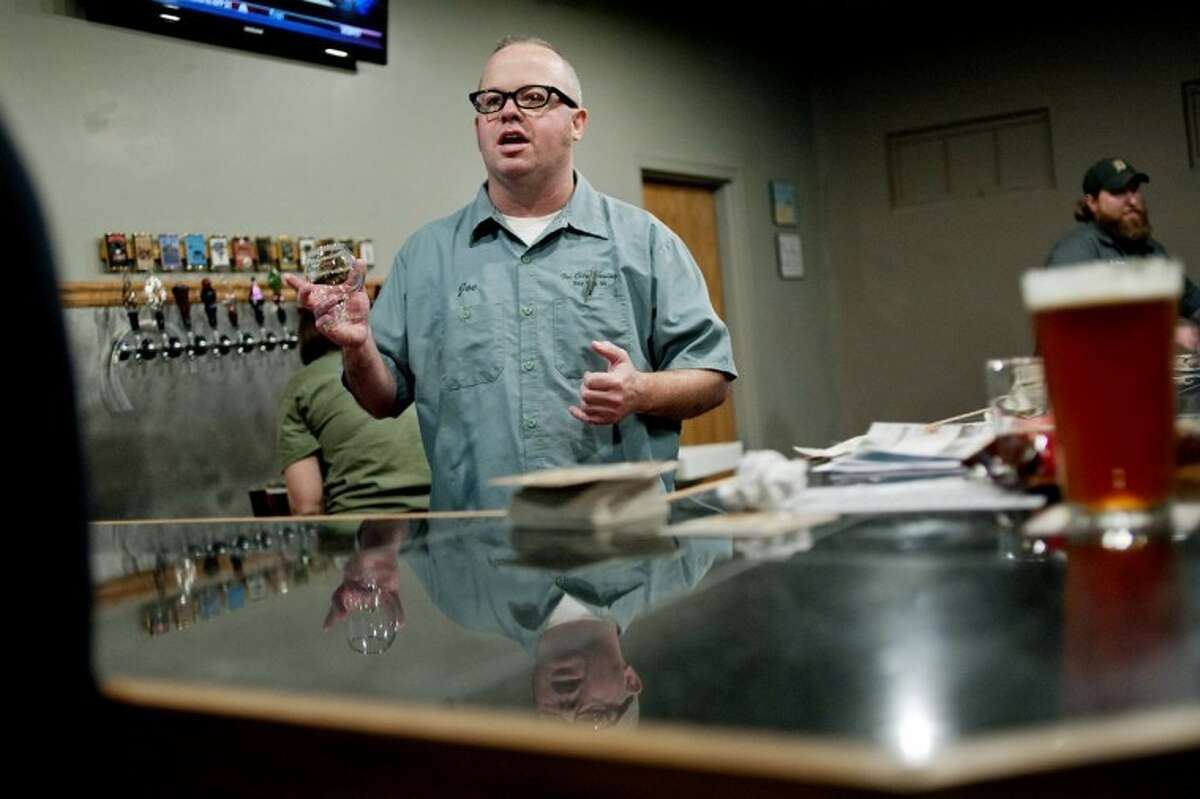NICK KING | nking@mdn.netJoe Hackett takes orders behind the bar at the Tri City Brewing Co. taproom Thursday in Bay City. The taproom, which opened on Thursday, offers 12 different beers to sample. Tri City Brewing Co. is celebrating its fifth anniversary.