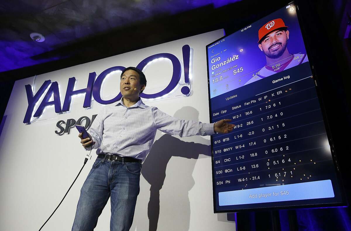 Kelly Hirano, vice president of engineering, demonstrates the Yahoo Sports Daily Fantasy contest during a product launch Wednesday, July 8, 2015, in San Francisco. Yahoo has designed this experience for the mobile fantasy player and offers Daily Fantasy, Full Season Fantasy, and real-time sports news and scores as an all-in-one experience. (AP Photo/Eric Risberg)