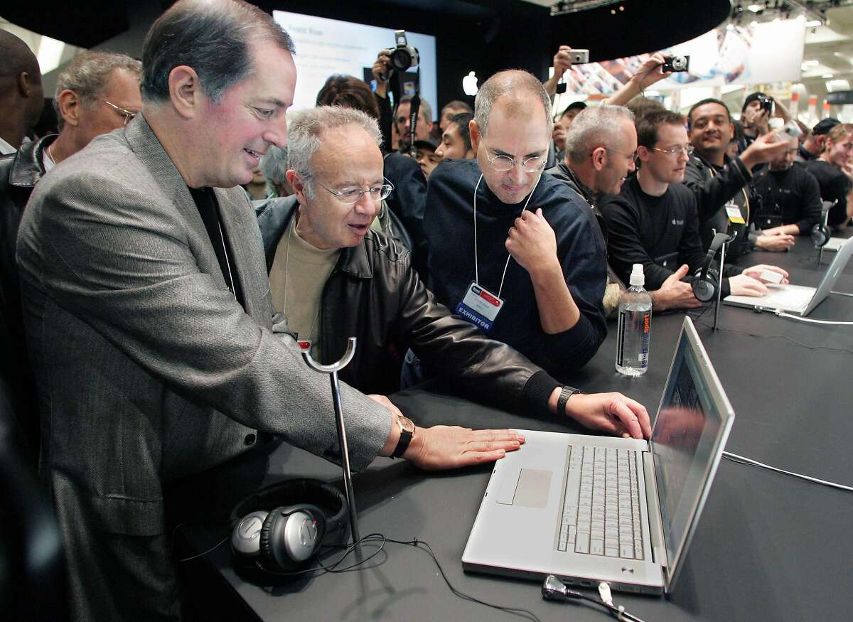 From left to right, Intel CEO Paul Otellini, former Intel CEO Andy Grove and Apple CEO Steve Jobs look at a MacBook Pro at the Macworld Conference and Expo in San Francisco in January 2006.