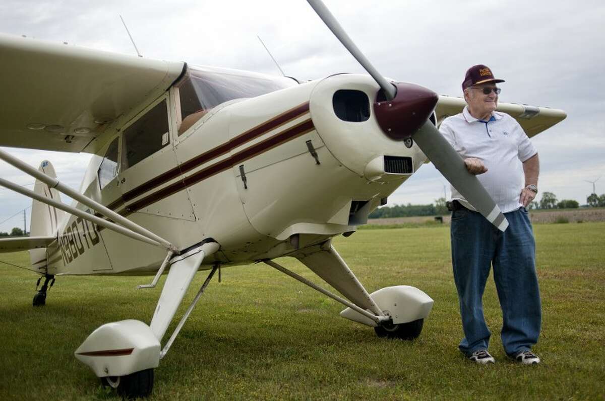 NICK KING | nking@mdn.netRon Schultz poses with the Piper Pacer airplane which he has been flying for more than 20 years. Schultz uses the plane to take trips and uses a grass runway that is next to his property in Shepherd. Schultz has received a Wright Brothers Master Pilot Award, which means he's safely flown for 50 consecutive years.