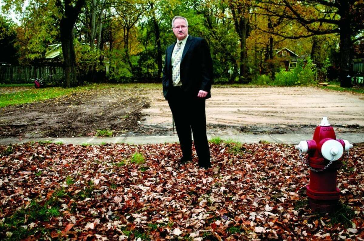 Midland Police Detective Lt. Greg Kramer stands in front of a lot on Mill Street where a house once stood. The home that used to be there was a drug house and was demolished after the occupants were arrested for selling crack cocaine.