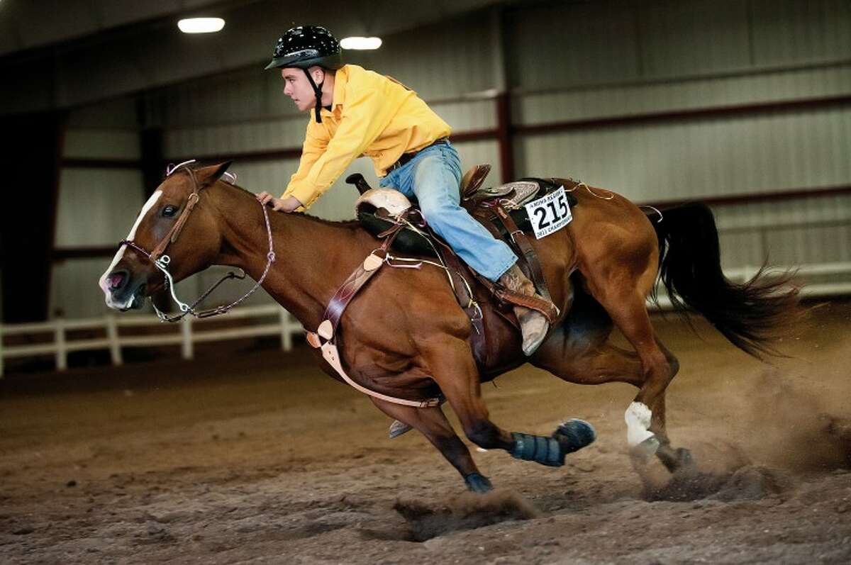 NEIL BLAKE | nblake@mdn.net Brandt Gaffke, a freshman on the Bullock Creek equestrian team, races his horse Sadie across the finish line during the cloverleaf event at the regional championship on October 1 at the Midland County Fairgrounds. This weekend Bullock Creek will compete at the state championship at the Midland County Fairgrounds in Class A. H.H. Dow's Class B team qualified as well. Competition begins at 1 p.m. on Thursday and continues through Sunday morning. This is Bullock Creek's fifth straight appearance at the state championship.