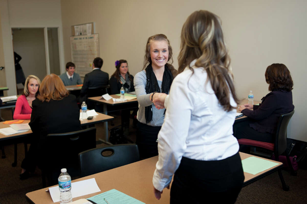 Midland High junior Emily Burrell, left, greets Chemical Bank Administrative Assistant Ashlie Kreger before starting a mock interview at Davenport University on Tuesday. Burrell was one of hundreds of Midland County students to go through the annual "Ready, Set, GET HIRED!" program which strives to prepares students for their first interviews.