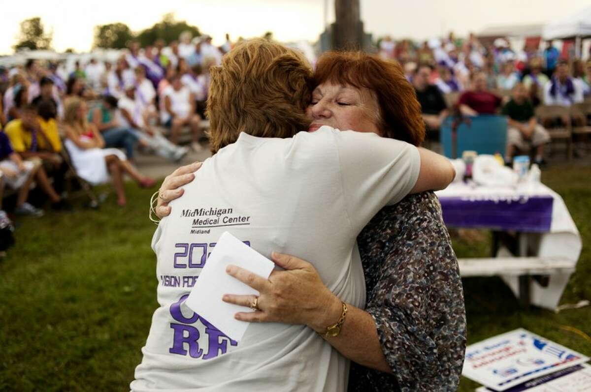 Joan Herbert of Midland, left, embraces Linda Dielman of Mt. Pleasant after Dielman spoke at the Survivor/Caregiver Ceremony at Relay for Life of Midland County on Saturday evening. Dielman talked about caring for her husband, Everett Dielman, in his final days with cancer. He passed away in 2009. The 24 hour relay started at 9 a.m. on Saturday morning and teams stayed up through the night walking to fight back against cancer.