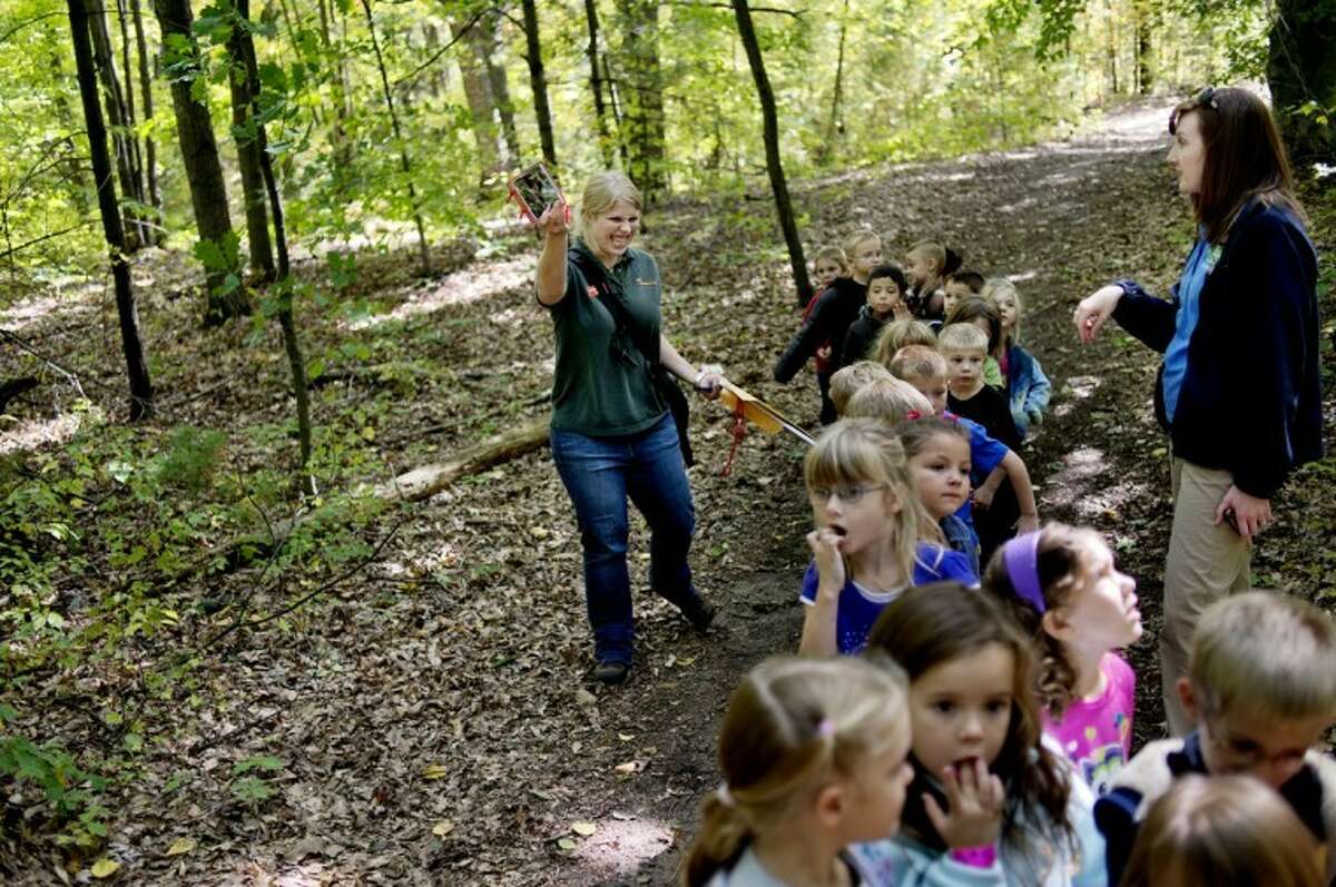 NICK KING | nking@mdn.netChippewa Nature Center educator Michelle Fournier, left, leads Erin Southwell's kindergarten class on a nature walk outside Floyd Elementary School. Fournier gave a lesson to the students about classifying insects and other animals.
