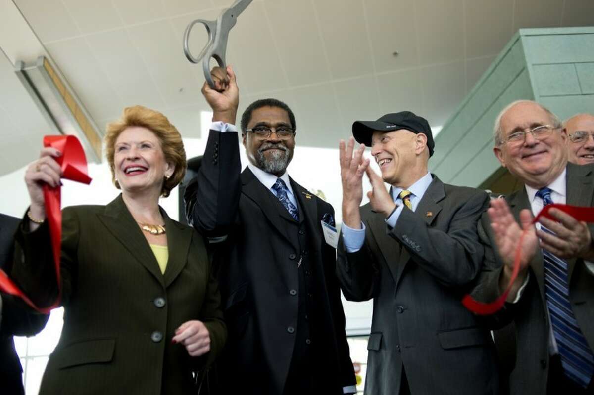 From left, U.S. Sen. Debbie Stabenow, D-Mich., airport commission chairman Darnell Earley, U.S. Rep. Dave Camp, R-Mich., and U.S. Sen. Carl Levin, D-Mich., celebrate after cutting a ribbon during an unveiling ceremony for MBS International Airport's new terminal on Friday. Guests included legislative representatives, government officials and community leaders from the Great Lakes Bay Region. The new 75,000 square-foot terminal replaces the old one and will be open next week.