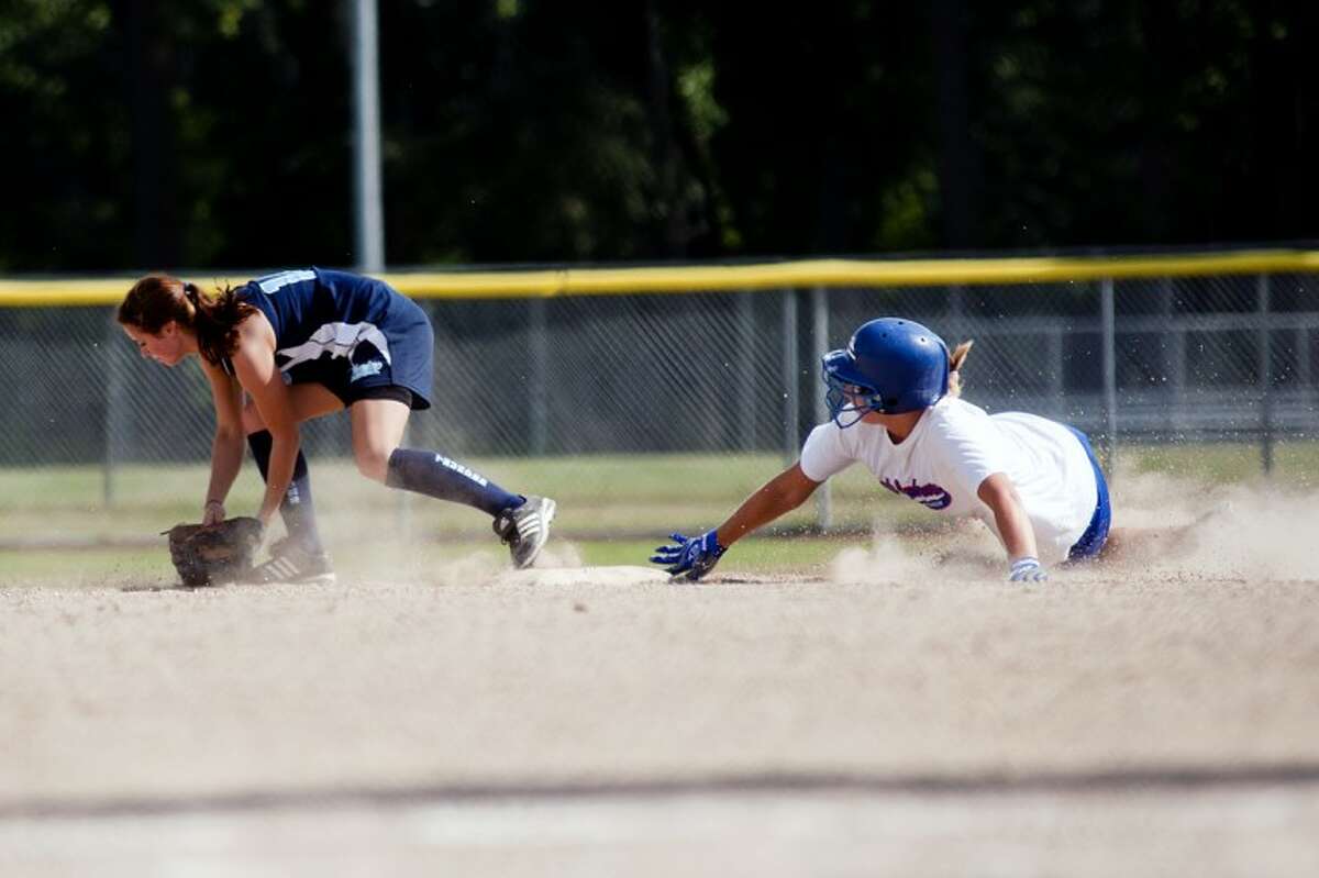 SARA WINKLER | for the Daily NewsKC Christopher of the Lady Explorers slides into second base safely as the Pinconning player misses the ball in the fifth inning of a game played Saturday evening at Currie Stadium in Emerson Park.