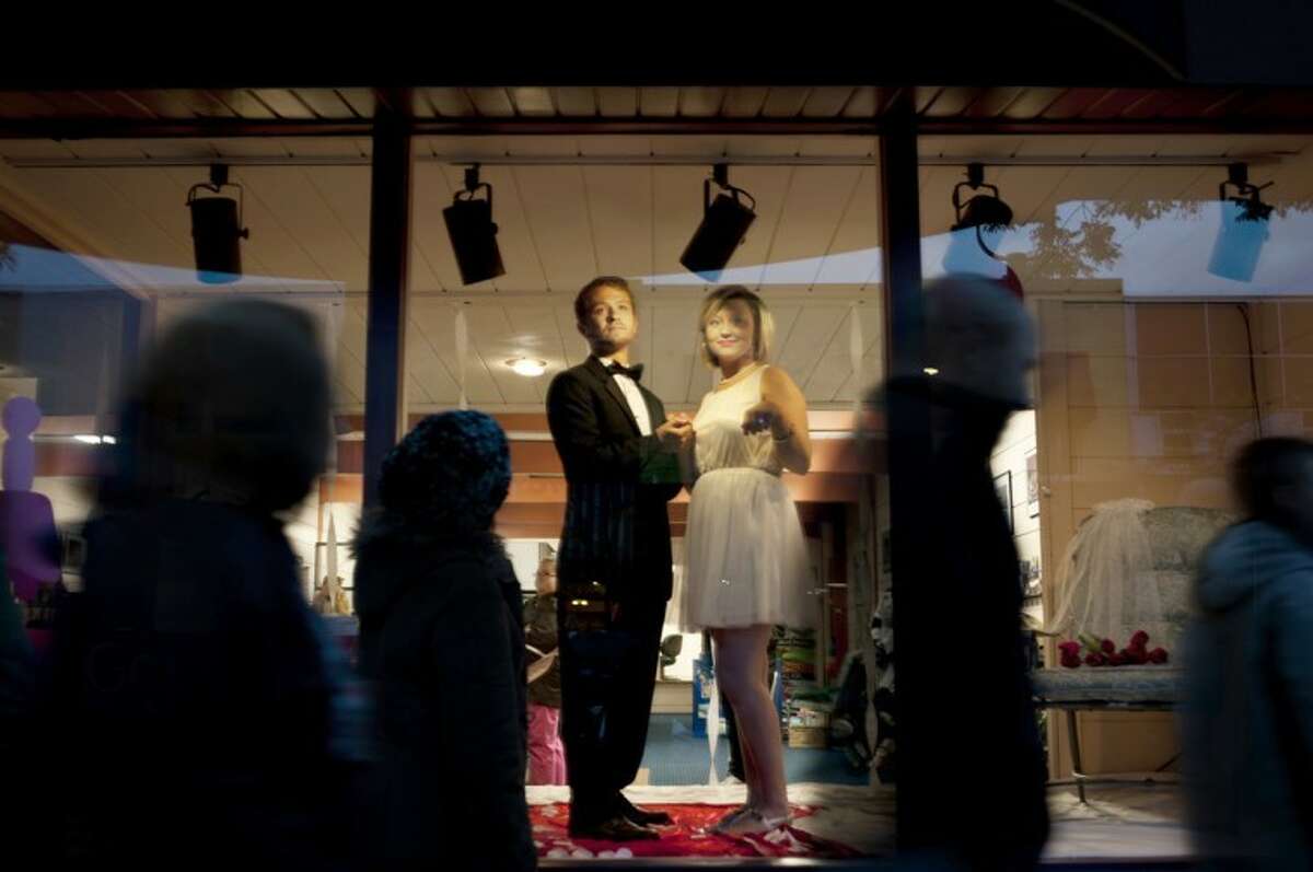 ZACK WITTMAN | for the Daily NewsNorthwood students Charlie Corconan, a junior, and Nina Chiaravalli, a sophomore, stand frozen in the window of the Midland County Convention and Visitors Bureau while people walk past during Mannequin Night on Thursday.
