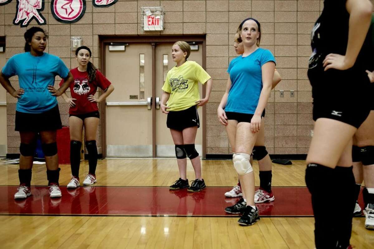SEAN PROCTOR | sproctor@mdn.netKirsten Longstreth, center, wearing a yellow shirt, takes part in practice with her teammates, including Ashton Snyder, left, Jasmyn Parker-Urban, and Chloe Zukar at Beaverton High School. Longstreth was diagnosed with Hodgkins Lymphoma in March and subsequently went through eight cycles of chemotherapy. Her coach, Steve Evans, wasn't sure she would be able to play this season, but is excited to have her back on the team. "She has a good attitude and is a hard worker. A team player and a great participator," he said.