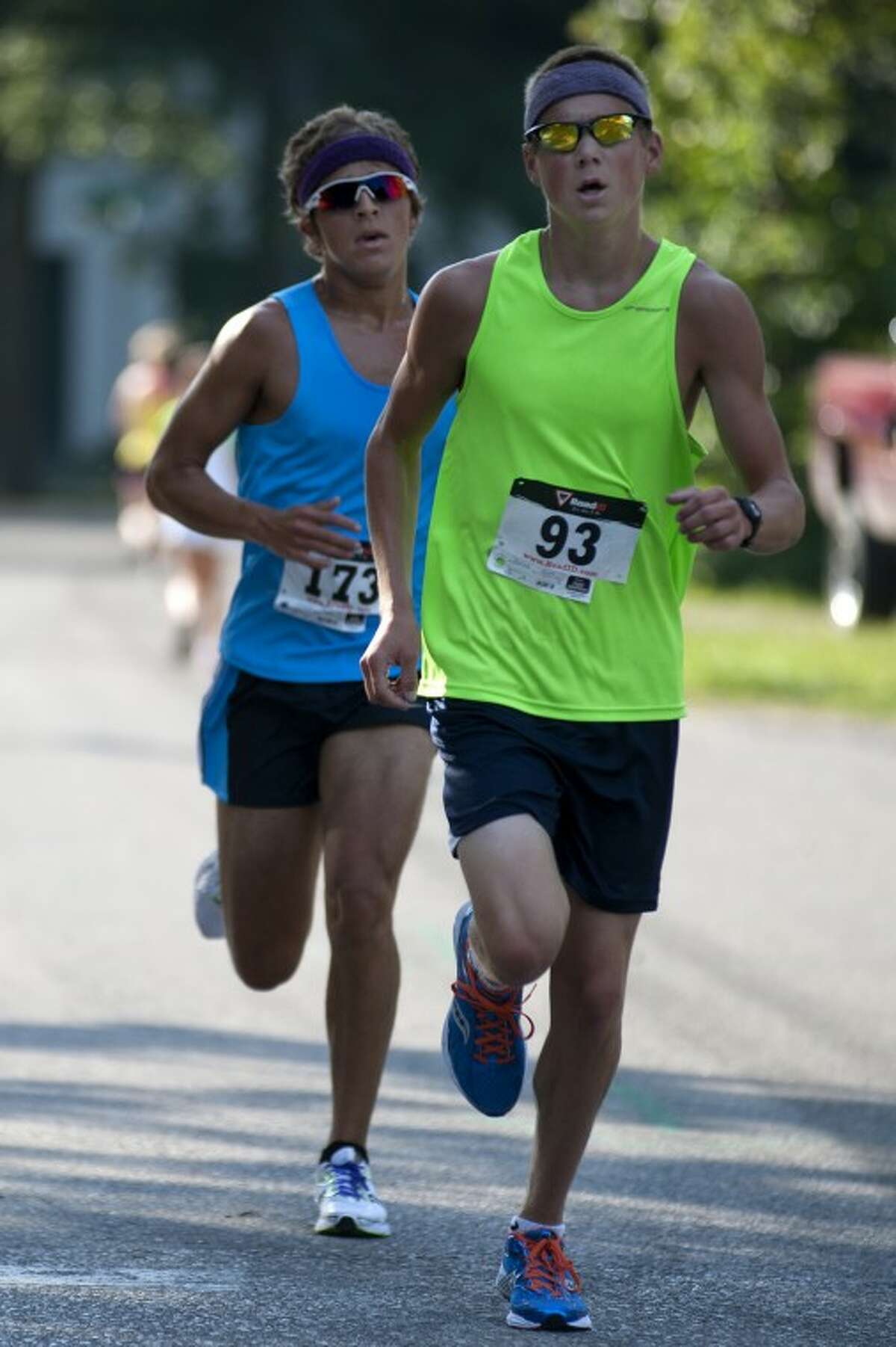 BRITTNEY LOHMILLER | blohmiller@mdn.netJesse Corbat, left, and Kurt Gulick race to the finish line of the second annual Coach Bob Cole Memorial 5K in Sanford Saturday morning.