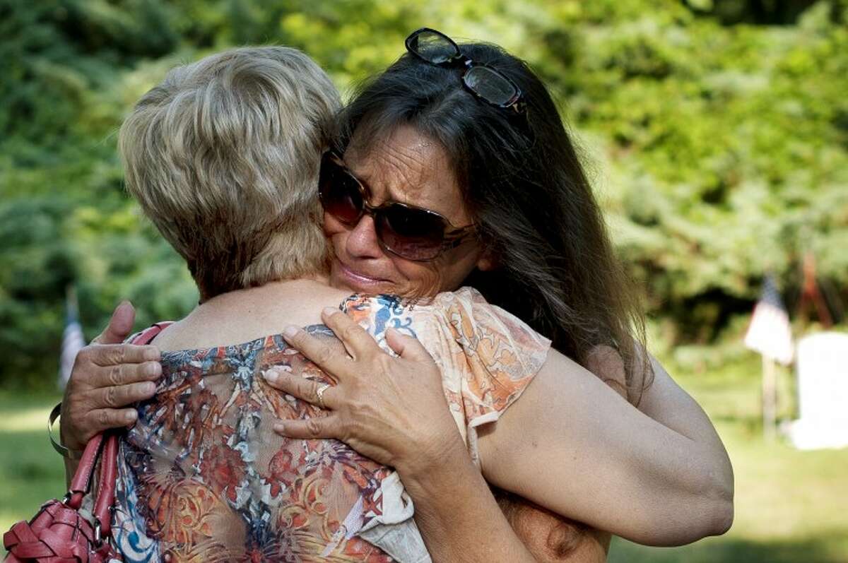 BRITTNEY LOHMILLER | blohmiller@mdn.netKaren Bauer of Freeland hugs Debi Bartley-Ullom, Aaron's mother, before the balloon release for her son. "It doesn't get any better," said Bartley-Ullom to Bauer.